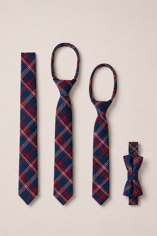 Four Mariner Tartan ties from Ivy City Co—including two kids' zipper ties, one standard cotton tie, and one bow tie—are laid out vertically on a light beige background. Each piece features the signature red, navy, and white plaid pattern of the "Ties in Mariner Tartan" collection, making them perfect for weddings or any special occasion.