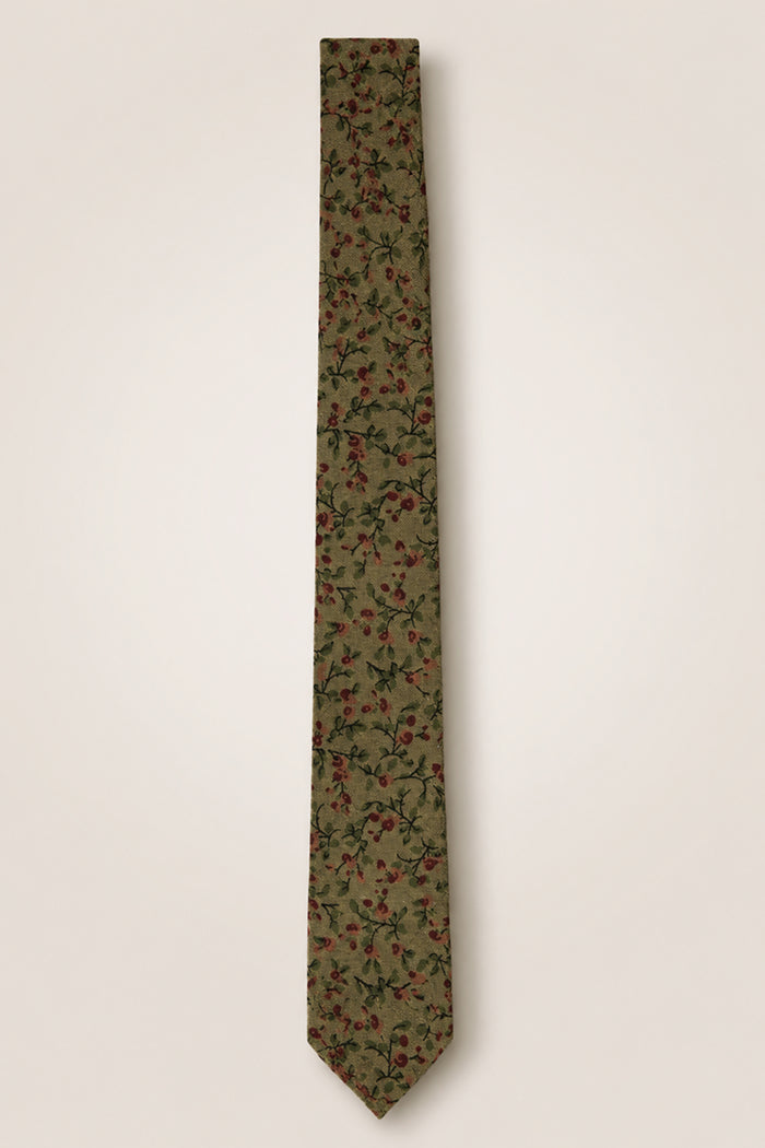 Introducing the Ivy City Co Ties in Woodland Floral—a green cotton tie adorned with a delicate pattern of small red and pink flowers and lush green leaves set against a light beige background. Perfect as a wedding accessory for nature-themed celebrations.