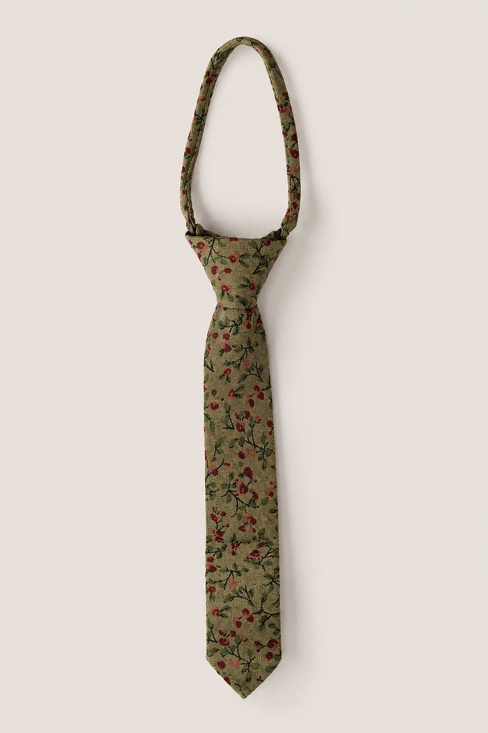 Discover the Ties in Woodland Floral by Ivy City Co—a soft cotton green necktie adorned with a woodland floral pattern of red flowers and green leaves, beautifully photographed against a simple light background. The perfect accessory for weddings.