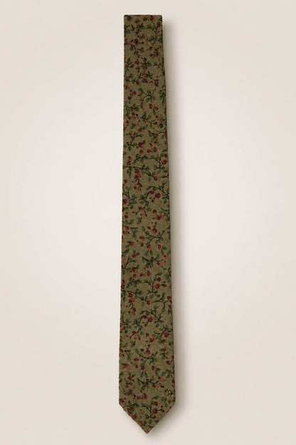 The Ties in Woodland Floral by Ivy City Co showcase an olive green cotton fabric adorned with a delicate pattern of small red flowers and green leaves, displayed flat against a plain light background—an elegant accessory perfect for any nature-inspired wedding celebration.