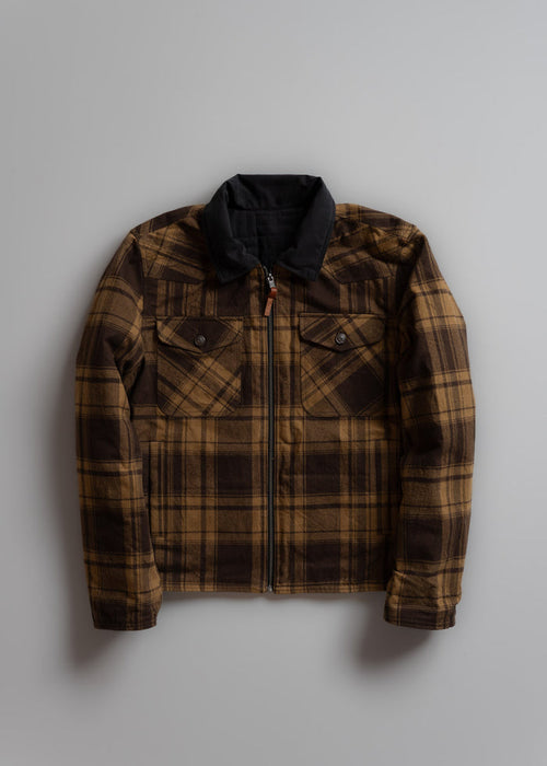 Brown plaid jacket with a black collar and buttoned chest pockets, displayed on a gray background.