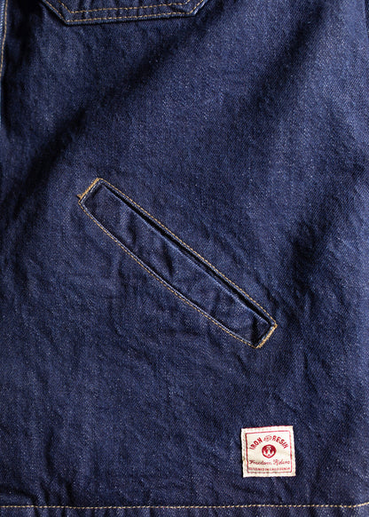 Denim fabric with a diagonal pocket and a small "Iron and Resin" label at the bottom, showcasing rugged style and craftsmanship.