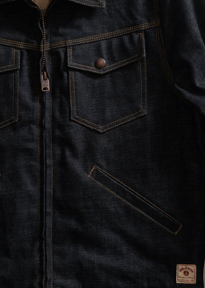 Dark denim jacket with front zipper, two chest pockets with buttons, and a small label at the bottom right corner.