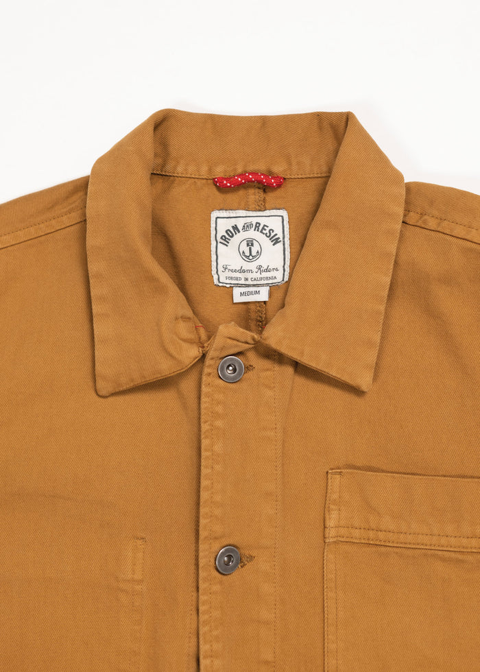Brown button-up shirt with a collar, featuring a "Iron and Resin" label inside. A small red loop is visible near the label.