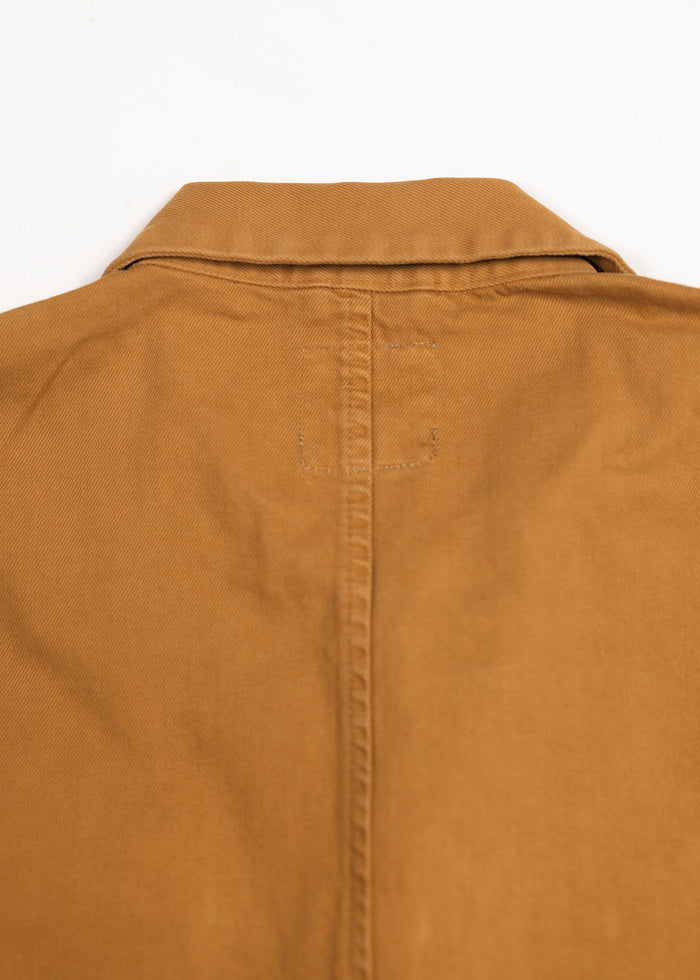 Close-up of a brown jacket's back, showing a neat collar and central seam. The fabric appears durable and well-stitched.