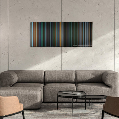 X2: X-Men United color palette canvas on a concrete wall above a gray sectional sofa